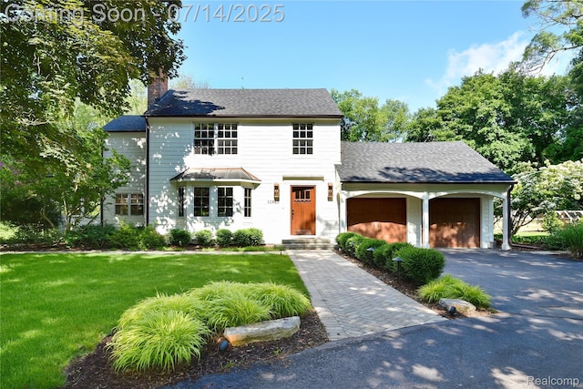 32965 Franklin Ct, Franklin, MI 48025 - view of front of property with a chimney, driveway, a garage, and a front yard
