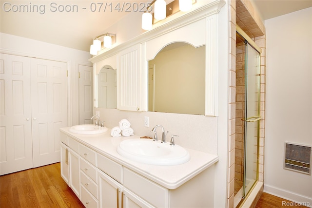 32965 Franklin Ct, Franklin, MI 48025 - bathroom with wood finished floors, a stall shower, double vanity, and heating unit