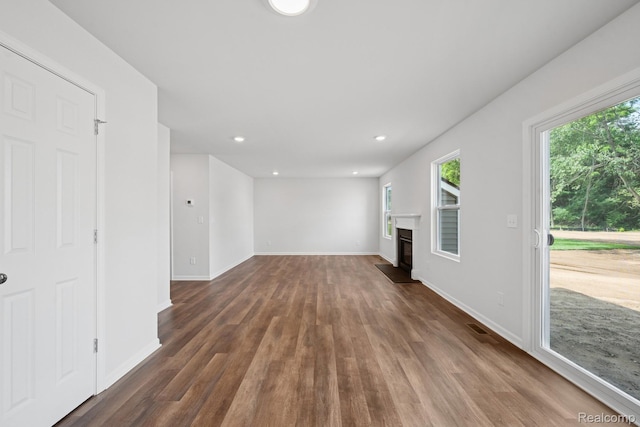4311 Oak St, Grand Blanc, MI 48439 - unfurnished living room with dark wood-type flooring, a glass covered fireplace, and recessed lighting