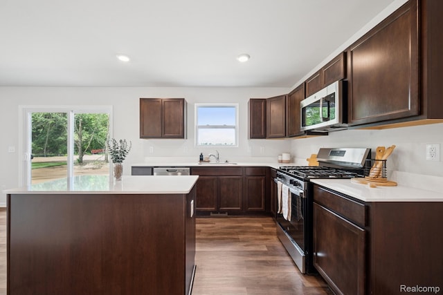 4311 Oak St, Grand Blanc, MI 48439 - kitchen with appliances with stainless steel finishes, dark wood-style floors, dark brown cabinets, light countertops, and recessed lighting