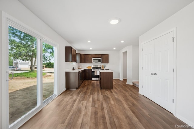 4311 Oak St, Grand Blanc, MI 48439 - kitchen featuring stainless steel appliances, dark brown cabinetry, light countertops, dark wood-type flooring, and recessed lighting