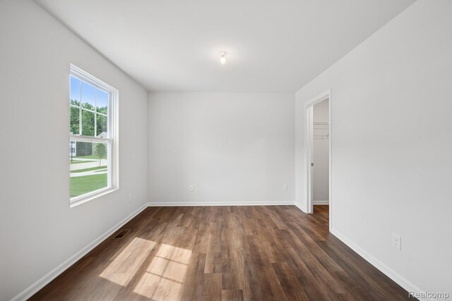 4311 Oak St, Grand Blanc, MI 48439 - spare room featuring dark wood finished floors and baseboards