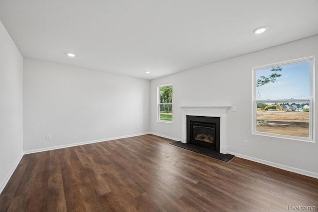 4311 Oak St, Grand Blanc, MI 48439 - unfurnished living room featuring a glass covered fireplace, dark wood-style floors, and recessed lighting