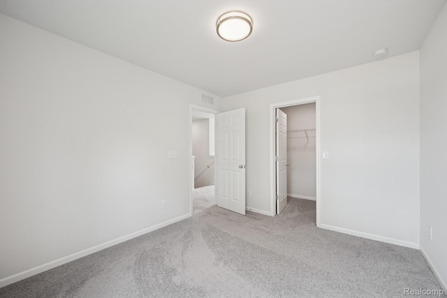 4311 Oak St, Grand Blanc, MI 48439 - unfurnished bedroom with carpet, a spacious closet, and a closet