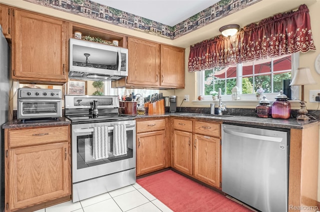 54286 Bradshaw Dr, New Baltimore, MI 48047 - kitchen with appliances with stainless steel finishes, dark countertops, light tile patterned floors, and open shelves