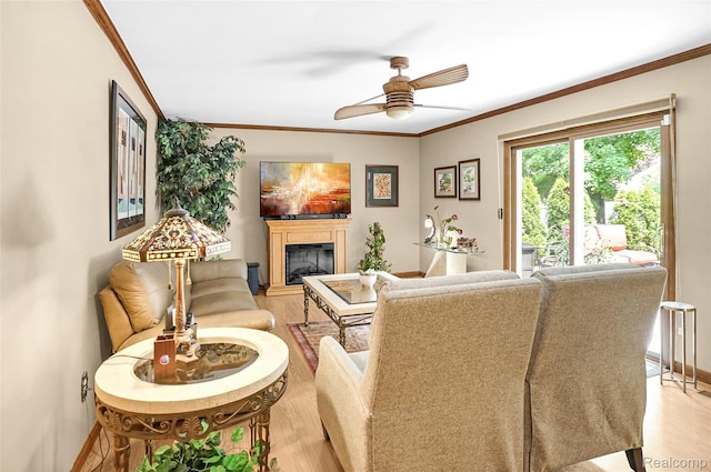 54286 Bradshaw Dr, New Baltimore, MI 48047 - living area featuring light wood finished floors, a ceiling fan, crown molding, and a glass covered fireplace