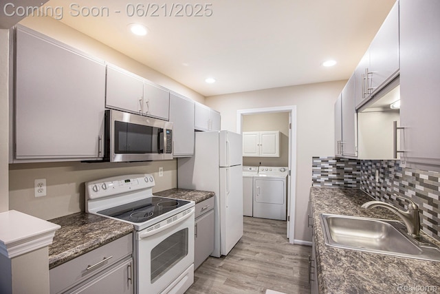 56217 Troon N, Utica, MI 48316 - kitchen with white appliances, separate washer and dryer, light wood finished floors, dark countertops, and recessed lighting