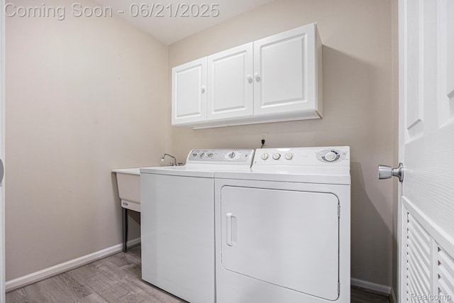56217 Troon N, Utica, MI 48316 - laundry room with cabinet space, separate washer and dryer, and light wood-style floors