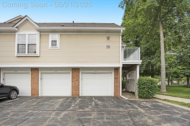 56217 Troon N, Utica, MI 48316 - view of property exterior with brick siding, asphalt driveway, an attached garage, and roof with shingles