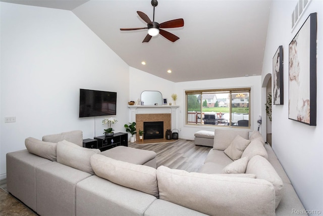 52854 Schafers Run Ct, New Baltimore, MI 48051 - living area with a ceiling fan, a tiled fireplace, wood finished floors, recessed lighting, and high vaulted ceiling