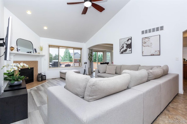 52854 Schafers Run Ct, New Baltimore, MI 48051 - living area with ceiling fan, arched walkways, high vaulted ceiling, a tile fireplace, and recessed lighting