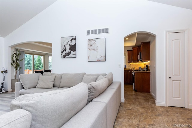 52854 Schafers Run Ct, New Baltimore, MI 48051 - living room featuring high vaulted ceiling and arched walkways