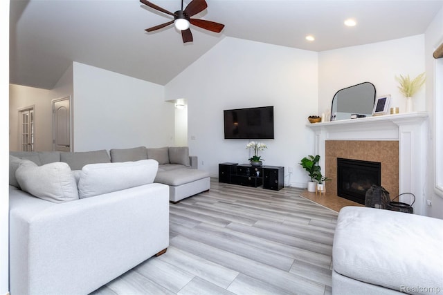 52854 Schafers Run Ct, New Baltimore, MI 48051 - living area featuring ceiling fan, a tile fireplace, high vaulted ceiling, recessed lighting, and light wood-style floors