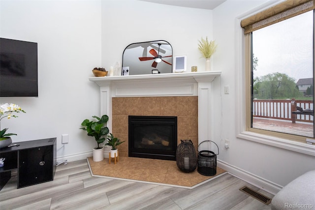 52854 Schafers Run Ct, New Baltimore, MI 48051 - living room featuring a ceiling fan, wood finished floors, and a tile fireplace