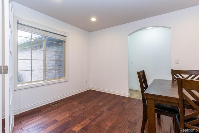 52854 Schafers Run Ct, New Baltimore, MI 48051 - unfurnished dining area with arched walkways, dark wood finished floors, and recessed lighting