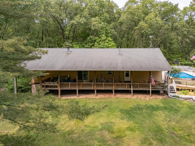 55840 Western Ave, Mattawan, MI 49071 - rear view of house with a lawn, an outdoor pool, a deck, and a view of trees