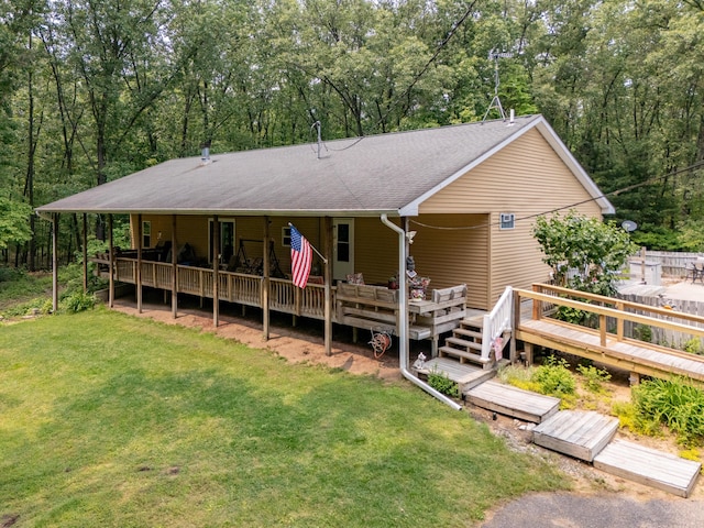 55840 Western Ave, Mattawan, MI 49071 - view of front of house with a front yard, roof with shingles, a wooden deck, and a forest view