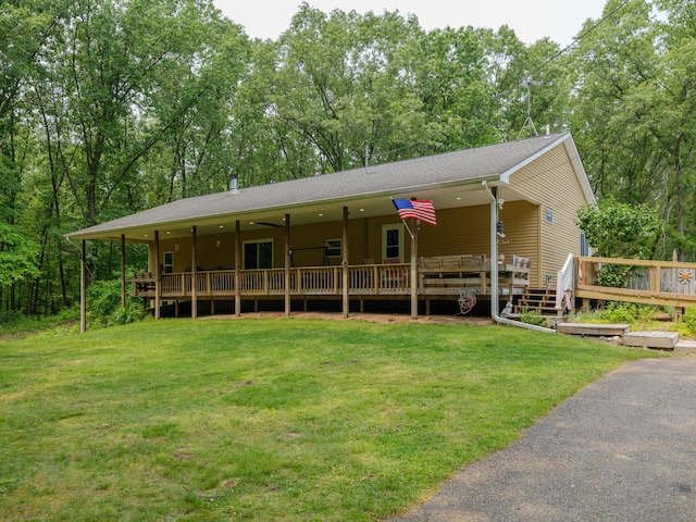 55840 Western Ave, Mattawan, MI 49071 - view of front facade with a front yard, a wooden deck, and a shingled roof