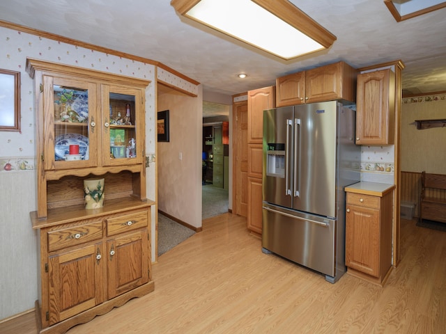 55840 Western Ave, Mattawan, MI 49071 - kitchen featuring stainless steel refrigerator with ice dispenser, wallpapered walls, light wood-style floors, glass insert cabinets, and light countertops