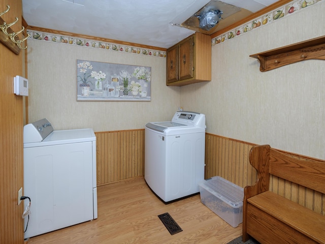 55840 Western Ave, Mattawan, MI 49071 - washroom with washing machine and clothes dryer, cabinet space, a wainscoted wall, light wood-type flooring, and wallpapered walls
