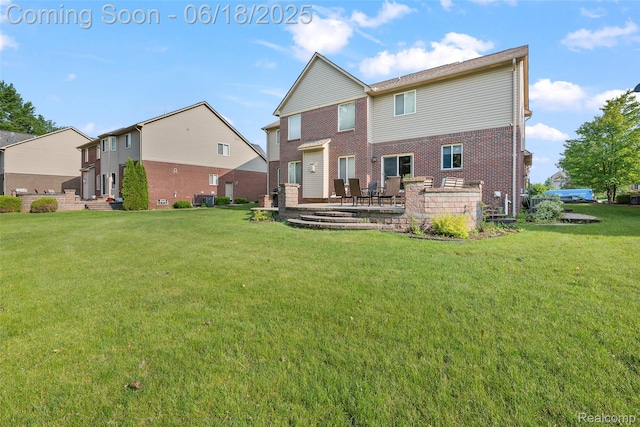 392 Gunston Ct, Troy, MI 48083 - rear view of house featuring a yard, brick siding, and a patio