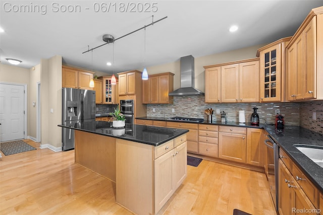 392 Gunston Ct, Troy, MI 48083 - kitchen featuring appliances with stainless steel finishes, wall chimney range hood, decorative backsplash, light wood-style floors, and a kitchen island