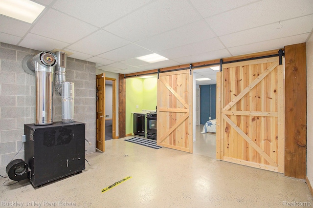 3278 Warner Rd, Howell, MI 48855 - basement featuring a barn door, concrete block wall, and a drop ceiling