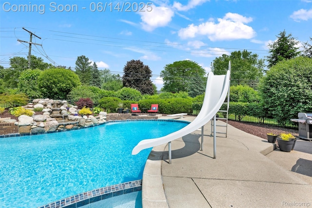 43115 Whisper Ct, Northville, MI 48168 - swimming pool with a water slide, grilling area, a patio, and view of scattered trees