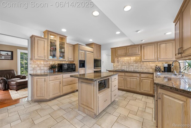 43115 Whisper Ct, Northville, MI 48168 - kitchen featuring decorative backsplash, light brown cabinets, glass insert cabinets, recessed lighting, and dark stone countertops