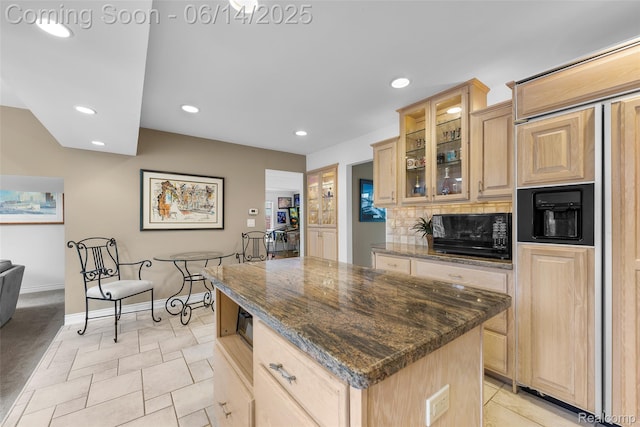 43115 Whisper Ct, Northville, MI 48168 - kitchen with light brown cabinets, black microwave, a kitchen island, recessed lighting, and glass insert cabinets