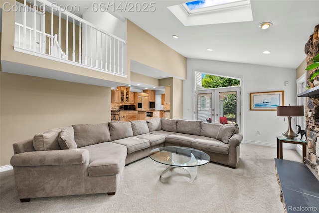 43115 Whisper Ct, Northville, MI 48168 - living room featuring a skylight, light carpet, a fireplace, recessed lighting, and french doors
