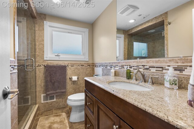 43115 Whisper Ct, Northville, MI 48168 - bathroom featuring vanity, a shower stall, and tile walls