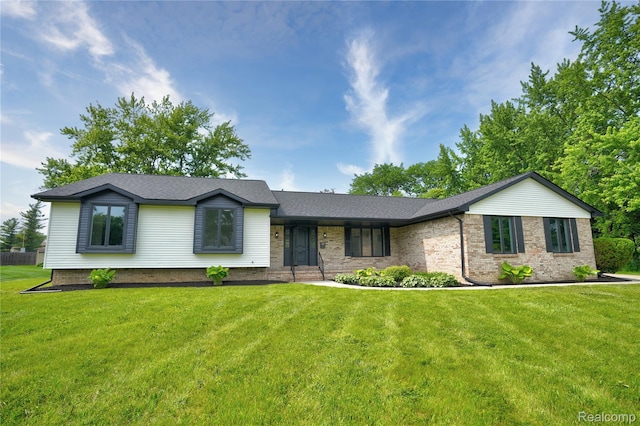 507 Charing Cross Dr, Grand Blanc, MI 48439 - view of front of property featuring a front yard, brick siding, and roof with shingles