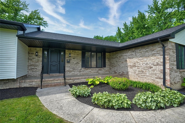 507 Charing Cross Dr, Grand Blanc, MI 48439 - entrance to property with covered porch, brick siding, and a shingled roof