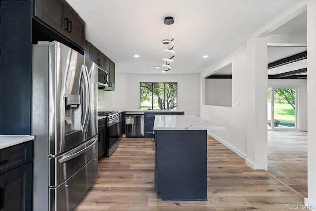 507 Charing Cross Dr, Grand Blanc, MI 48439 - kitchen with appliances with stainless steel finishes, plenty of natural light, light wood-style floors, recessed lighting, and a center island
