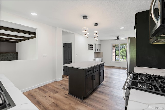 507 Charing Cross Dr, Grand Blanc, MI 48439 - kitchen featuring appliances with stainless steel finishes, a ceiling fan, light wood-style floors, dark cabinetry, and recessed lighting