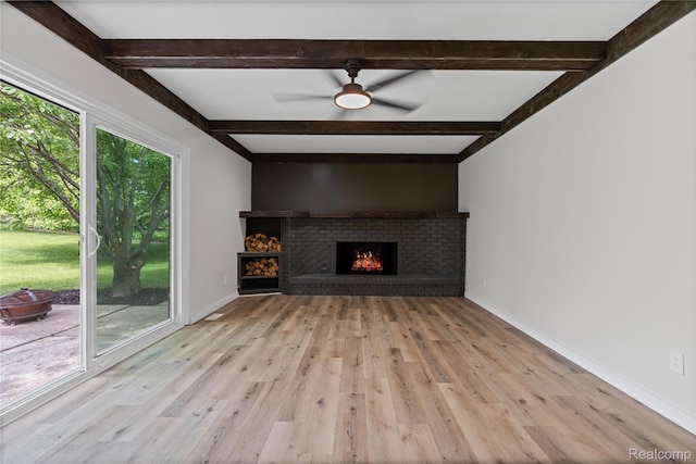 507 Charing Cross Dr, Grand Blanc, MI 48439 - unfurnished living room featuring light wood-style flooring, beam ceiling, a brick fireplace, and ceiling fan