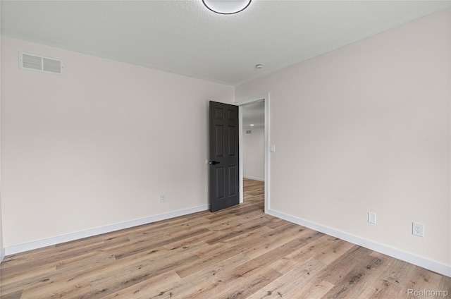 507 Charing Cross Dr, Grand Blanc, MI 48439 - spare room with light wood-style flooring and baseboards