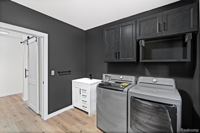 507 Charing Cross Dr, Grand Blanc, MI 48439 - laundry room featuring cabinet space, light wood-type flooring, and separate washer and dryer