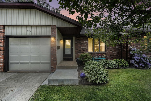 541 Maryland Ave NE Unit 39, Grand Rapids, MI 49503 - view of front of home with brick siding, a front yard, an attached garage, and concrete driveway