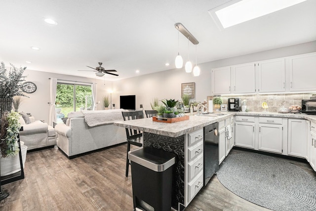 541 Maryland Ave NE Unit 39, Grand Rapids, MI 49503 - kitchen featuring stainless steel dishwasher, open floor plan, light countertops, a peninsula, and recessed lighting