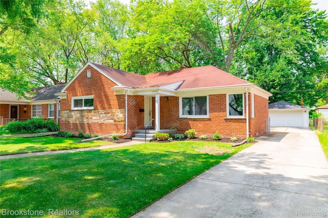 24251 Cloverlawn St, Oak Park, MI 48237 - view of front facade featuring an outdoor structure, a detached garage, brick siding, and a front lawn