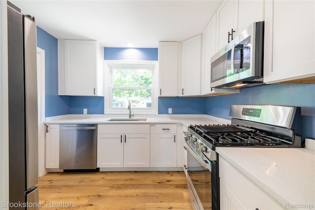 24251 Cloverlawn St, Oak Park, MI 48237 - kitchen featuring appliances with stainless steel finishes, white cabinetry, light wood-style floors, and recessed lighting