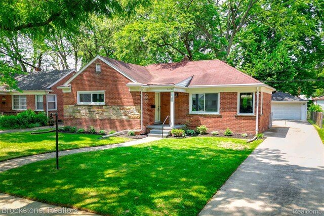 24251 Cloverlawn St, Oak Park, MI 48237 - view of front facade with an outbuilding, a garage, brick siding, a front yard, and a chimney