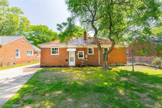 24251 Cloverlawn St, Oak Park, MI 48237 - back of house featuring brick siding, a chimney, and driveway