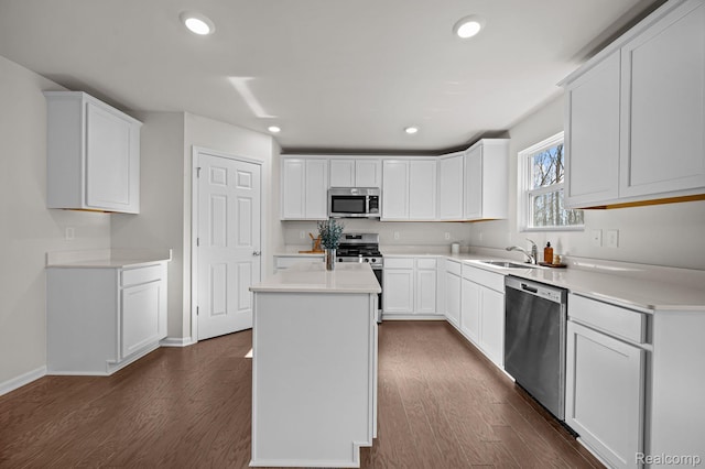 4278 Oak St, Grand Blanc, MI 48439 - kitchen featuring appliances with stainless steel finishes, dark wood-style flooring, a center island, recessed lighting, and light countertops