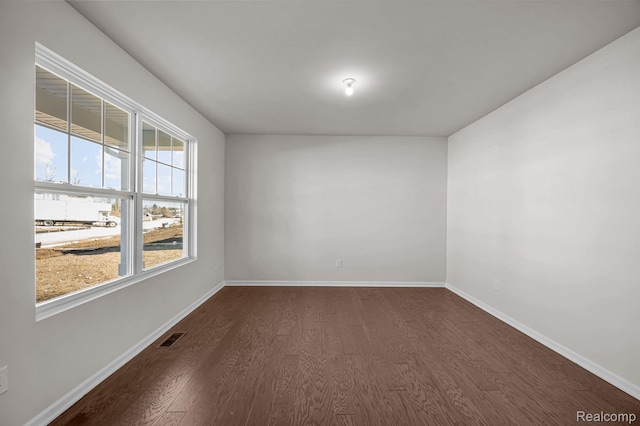 4278 Oak St, Grand Blanc, MI 48439 - spare room featuring dark wood-style floors and baseboards