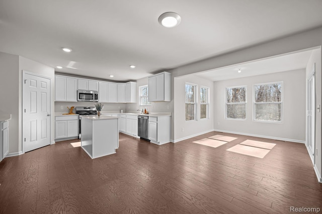 4278 Oak St, Grand Blanc, MI 48439 - kitchen with appliances with stainless steel finishes, light countertops, open floor plan, dark wood-type flooring, and recessed lighting