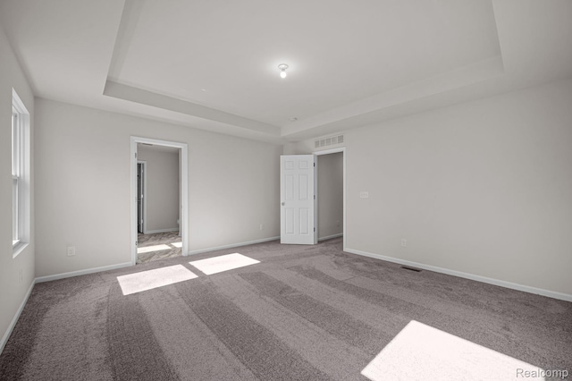 4278 Oak St, Grand Blanc, MI 48439 - unfurnished bedroom with a tray ceiling, light colored carpet, and multiple windows