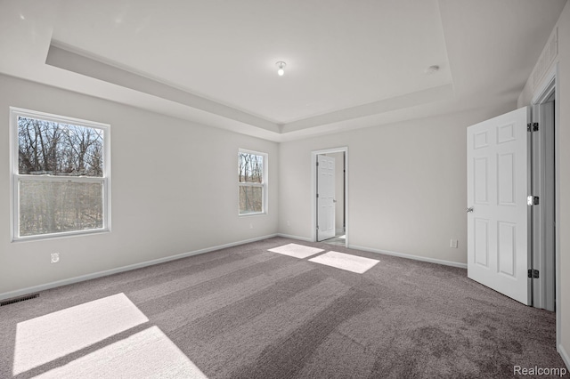 4278 Oak St, Grand Blanc, MI 48439 - unfurnished bedroom featuring a raised ceiling and carpet